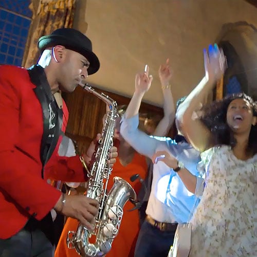 Saxophonist and Crowd dancing at a party